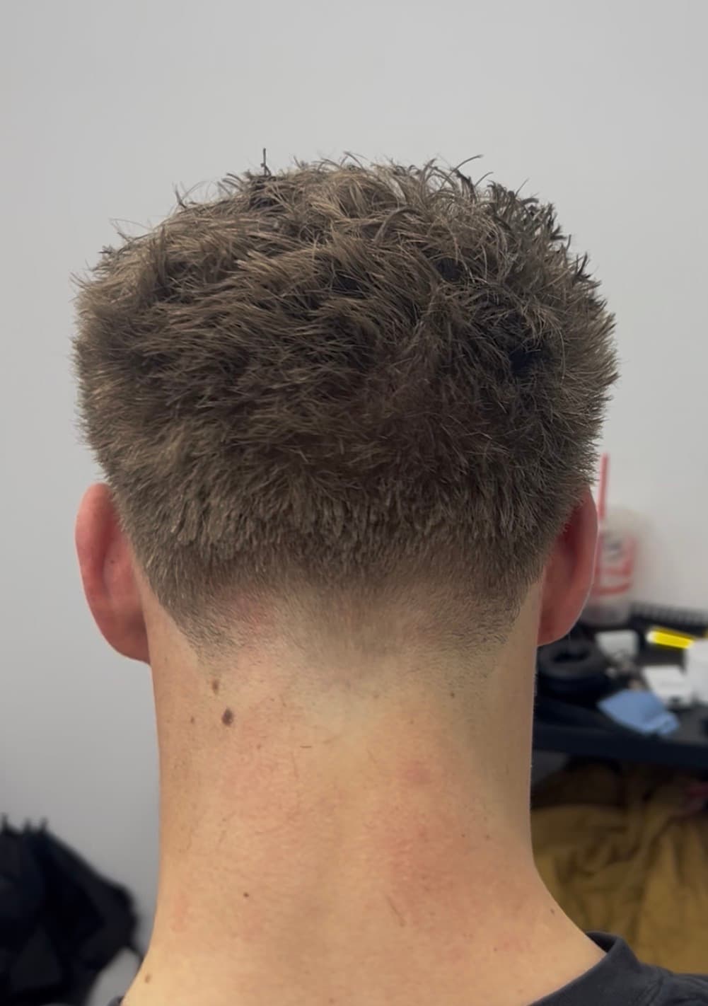 Clean low taper fade, back view